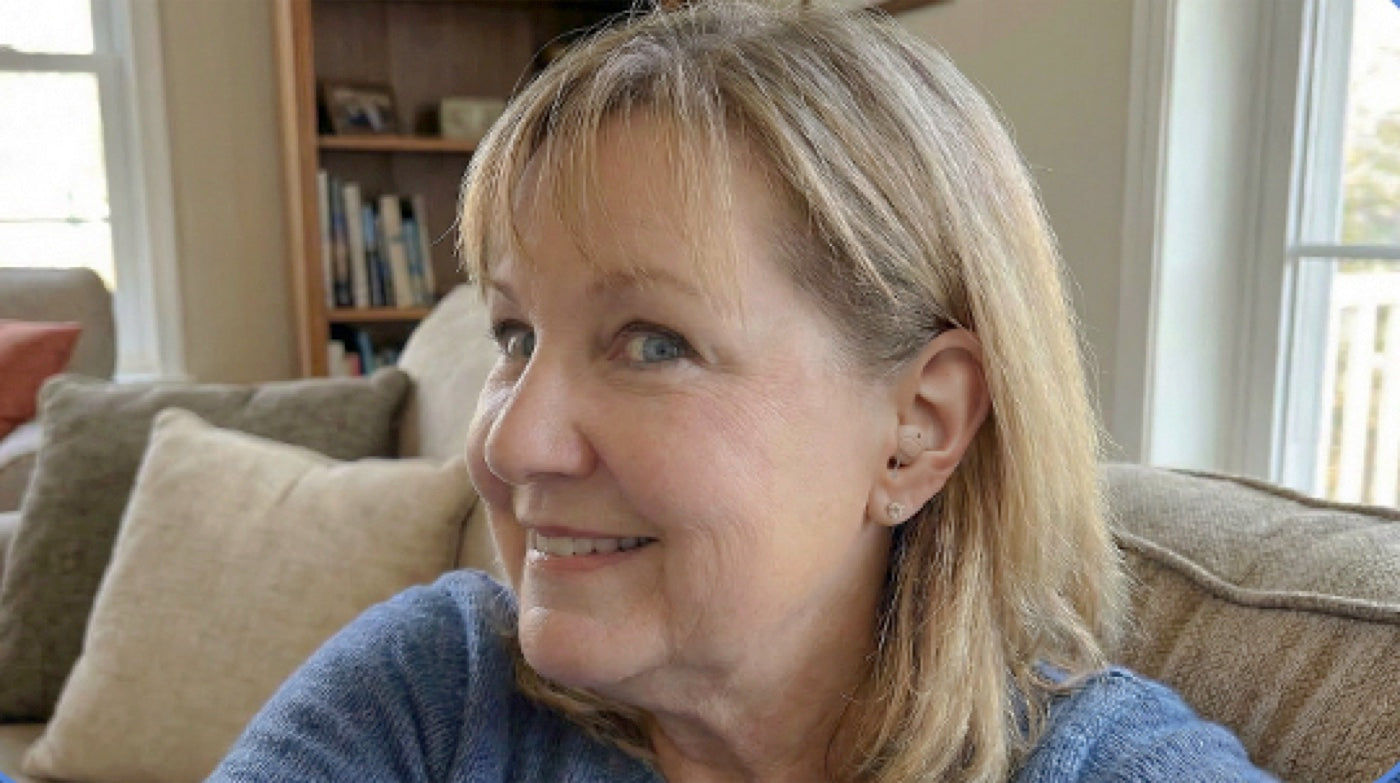 A hearo customer relaxing in her living room